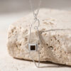 925 sterling silver Israel map necklace with Nano Bible resting on travertine stone