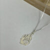 Sterling silver Hebrew flame pendant on a box chain on a light background