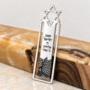 Sterling silver Star of David bookmark with Shema Yisrael and Western Wall design leaning on wood
