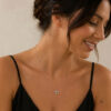 925 sterling silver dainty Chai necklace with Western Wall brick texture worn by a woman, side view