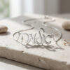 925 sterling silver custom Hebrew script name necklace with chain draped on stone