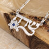 Close view of the Hebrew name necklace with Star of David and birthstone on olive wood, showing the cut-out Hebrew letters