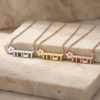 Sterling silver, 24K gold plated and rose gold plated Hebrew name necklace with birthstone flower necklaces on a stone block