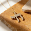 14K white gold pavé diamond Chai necklace on golden Jerusalem stone