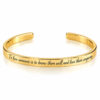 24K gold plated cuff bracelet engraved with an English quote in script font, on a white background