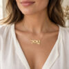 Woman wearing a 14K yellow gold Hebrew name necklace with a heart