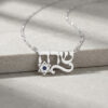 Sterling silver Hebrew name necklace with Star of David on a soft grey stone surface
