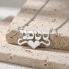 925 sterling silver Hebrew name necklace with heart resting on travertine stone