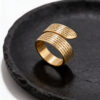 24K gold plated Eshet Chayil Hebrew wrap ring on a black stone plate