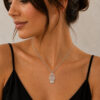 Woman wearing a delicate sterling silver Hamsa necklace with a Star of David