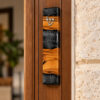 Handmade olive wood mezuzah case with gray epoxy mounted on a wooden doorpost of a Jewish home