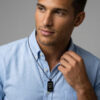 Man wearing the black dog tag necklace with Star of David engraving, showing how the pendant sits on the chest