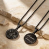 Black stainless steel compass necklace with a personal engraving on the back, on Jerusalem stone