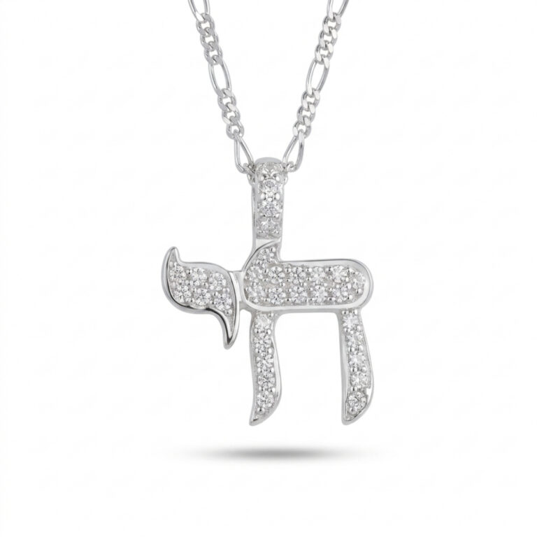 Sterling silver Hebrew Chai pendant set with cubic zirconia stones on a figaro chain, on a white background