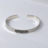 Side view of a sterling silver Jerusalem Wall cuff bracelet with Hebrew engraving