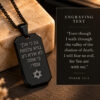 Black dog tag necklace beside a card with the English translation of Psalm 23:4, the verse engraved in Hebrew on the pendant