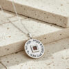 Close up of the sterling silver Nano Bible Eshet Chayil Necklace, round pendant engraved with the Hebrew Eshet Chayil (Woman of Valor) verse around a square nano Bible chip