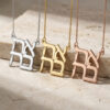 Sterling silver, 24K gold plated and rose gold plated stacked Ahava Hebrew love necklace necklaces hanging side by side on onyx