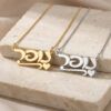 Two Hebrew name necklaces with hearts in 14K yellow and white gold on a stone block