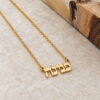 Gold plated tiny Hebrew name necklace on a travertine stone, dainty personalized Jewish name pendant