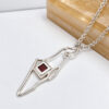 925 sterling silver Israel map necklace with Nano Bible close-up beside wood
