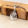 Sterling silver Hebrew flame pendant reading האש שלי (My Fire) hanging from an olive wood block
