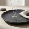 925 sterling silver dainty Chai necklace with Western Wall brick texture on a black stone plate