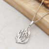 Sterling silver Hebrew flame necklace lying beside olive wood