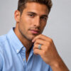Man in a light blue shirt wearing a sterling silver Jerusalem Wall Hebrew name band ring