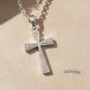 Zirconia Cross Necklace styled on chain — minimalist religious jewelry.