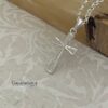 Sparkling cubic zirconia cross pendant detail.