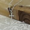 Cubic zirconia detail on dainty cross pendant.