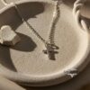 Dainty cross pendant macro detail.