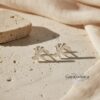 Sterling Silver Chai stud earrings styled on neutral linen and stone, elegant Jewish jewelry gift