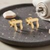 24K Gold Plated Hebrew Chai stud earrings on a dark stoneware plate, premium gold Jewish jewelry