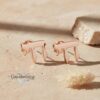 Rose Gold plated Chai earrings on warm beige sand, romantic rose gold Hebrew jewelry gift