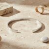 Engraved Cuff Bracelet Hidden Message Gift — dark surface composition, handmade in Israel