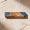 Olive Wood Mezuzah Case with Blue Epoxy — natural light shot, handmade in Israel