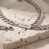 Personalized Stainless Steel Cuban Chain Necklace with Engraved Tag — top-down view, handmade in Israel