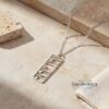 Elegant sterling silver Shema Israel tag necklace engraved with Hebrew prayer, displayed on a soft stone background – ha