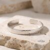 Hammered cuff bracelet with hidden engraving — handmade Judaica — main view