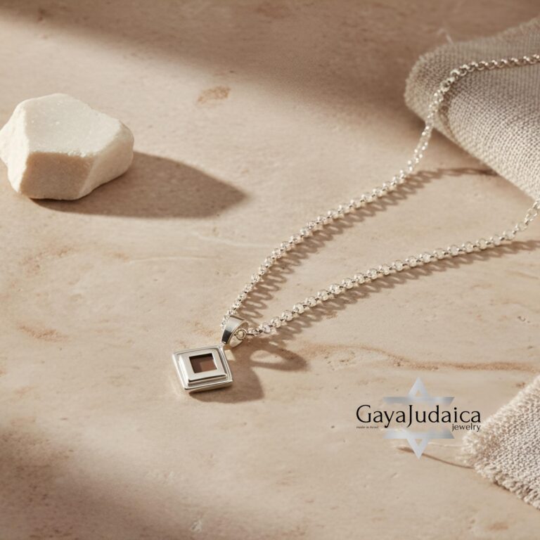 Sterling silver Nano Bible necklace featuring the entire Tanakh on a microchip pendant, displayed on a soft beige backgr