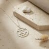 Round pendant necklace engraved with "Chesed and Emet" in Hebrew, handcrafted in sterling silver, displayed on