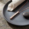 Rose gold plated 3D bar pendant engraved in Hebrew on a dark plate