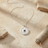 Sterling silver Shema Yisrael necklace with full chain laid out on sand next to twine and stone