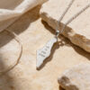 Sterling silver Israel map necklace engraved Ain Li Eretz Acheret in Hebrew, resting on a stone