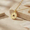 Gold plated Shema Israel nano Bible pendant with Hebrew prayer engraving on a stone ledge with linen