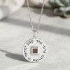 Close-up of the silver Shema Yisrael pendant with the nano Bible chip set in its square center window