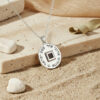 Silver Shema Israel pendant necklace with Hebrew engraving on a stone slab with sand and pebbles
