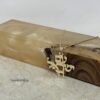 14K gold Am Yisrael Chai pendant on polished stone and wood